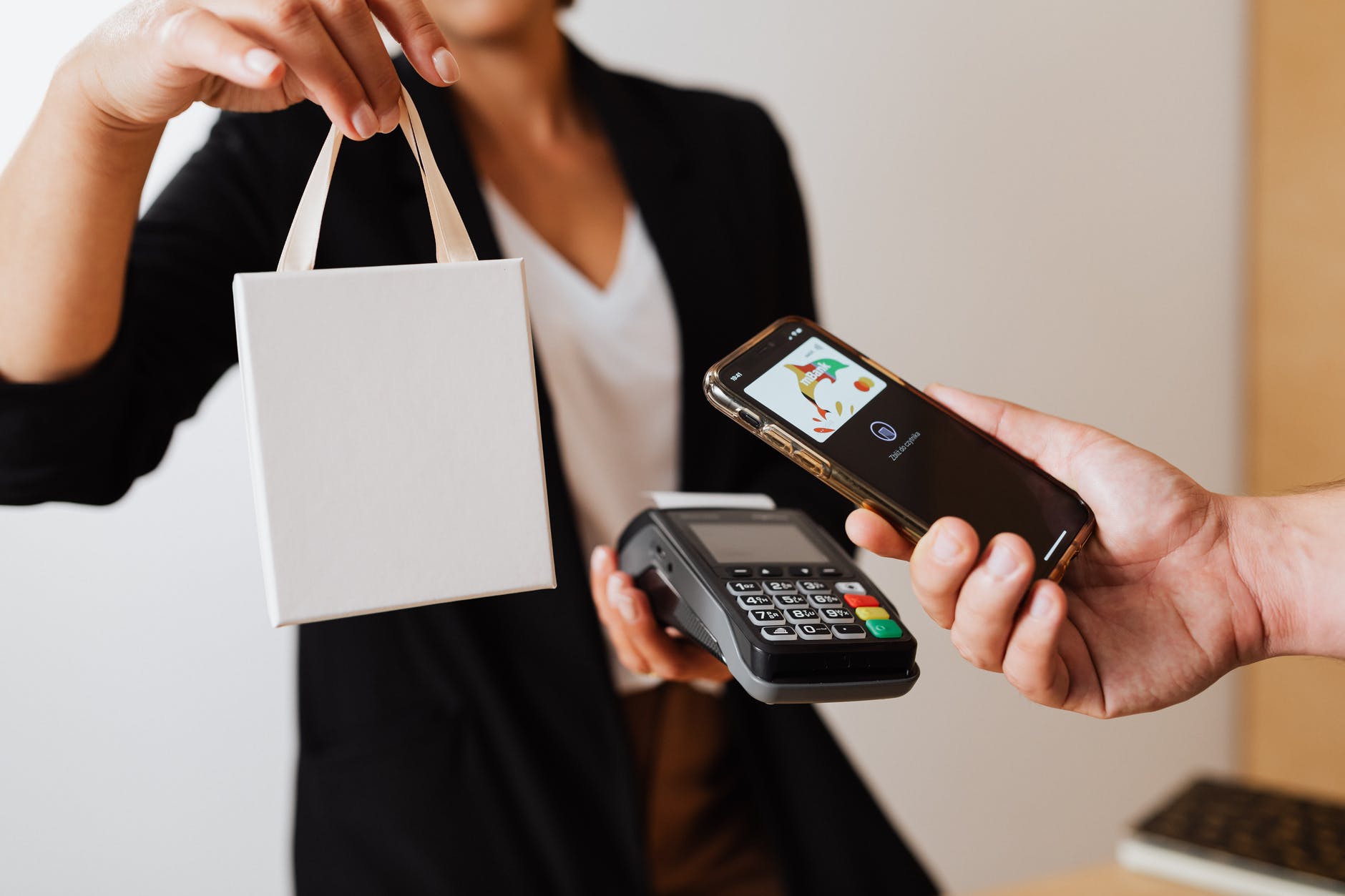 a person using mobile phone to pay cashless