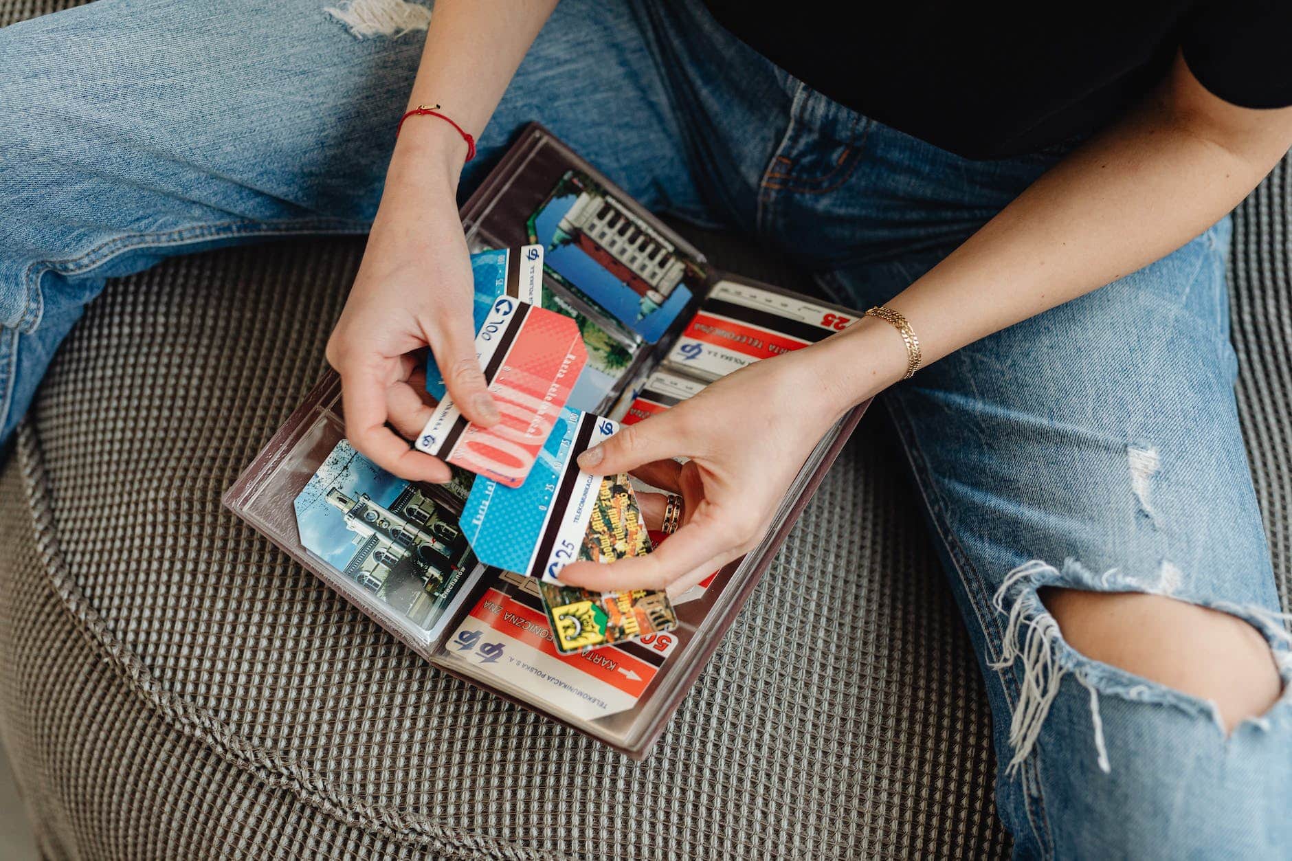 close up of a person holding a bunch of credit cards